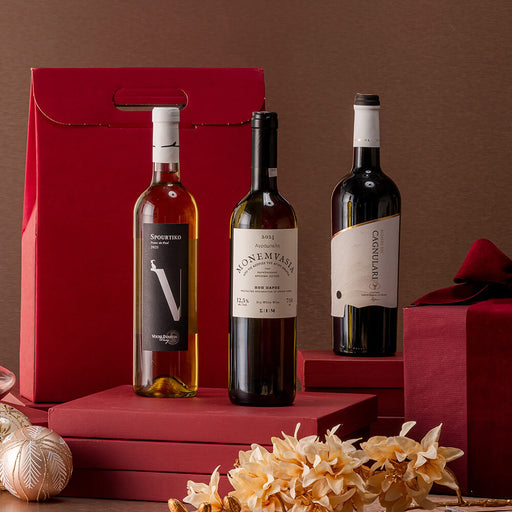 Three wine bottles on a red stand with decorative elements against a brown background