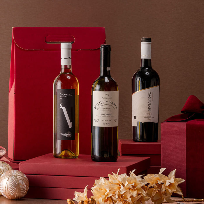 Three wine bottles on a red stand with decorative elements against a brown background