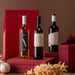 Three wine bottles on a red stand with decorative elements against a brown background