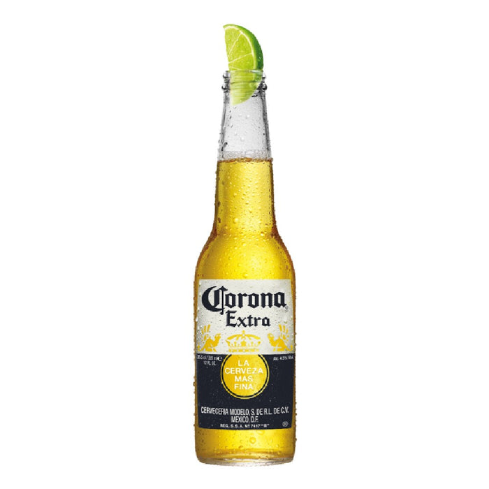 Corona Extra beer bottle with a lime wedge on a white background